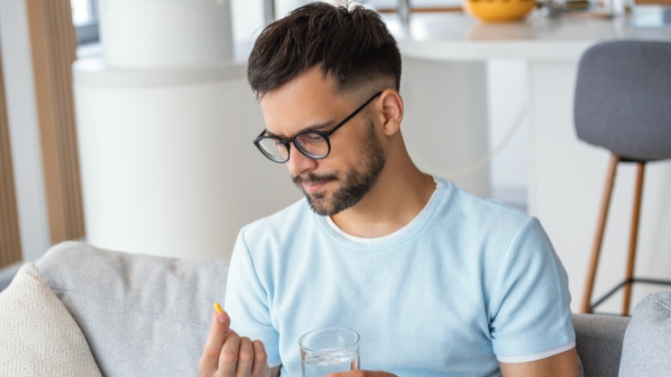 Un homme qui prend des antaIgiques pour son invisalign et la douleur du premier jour